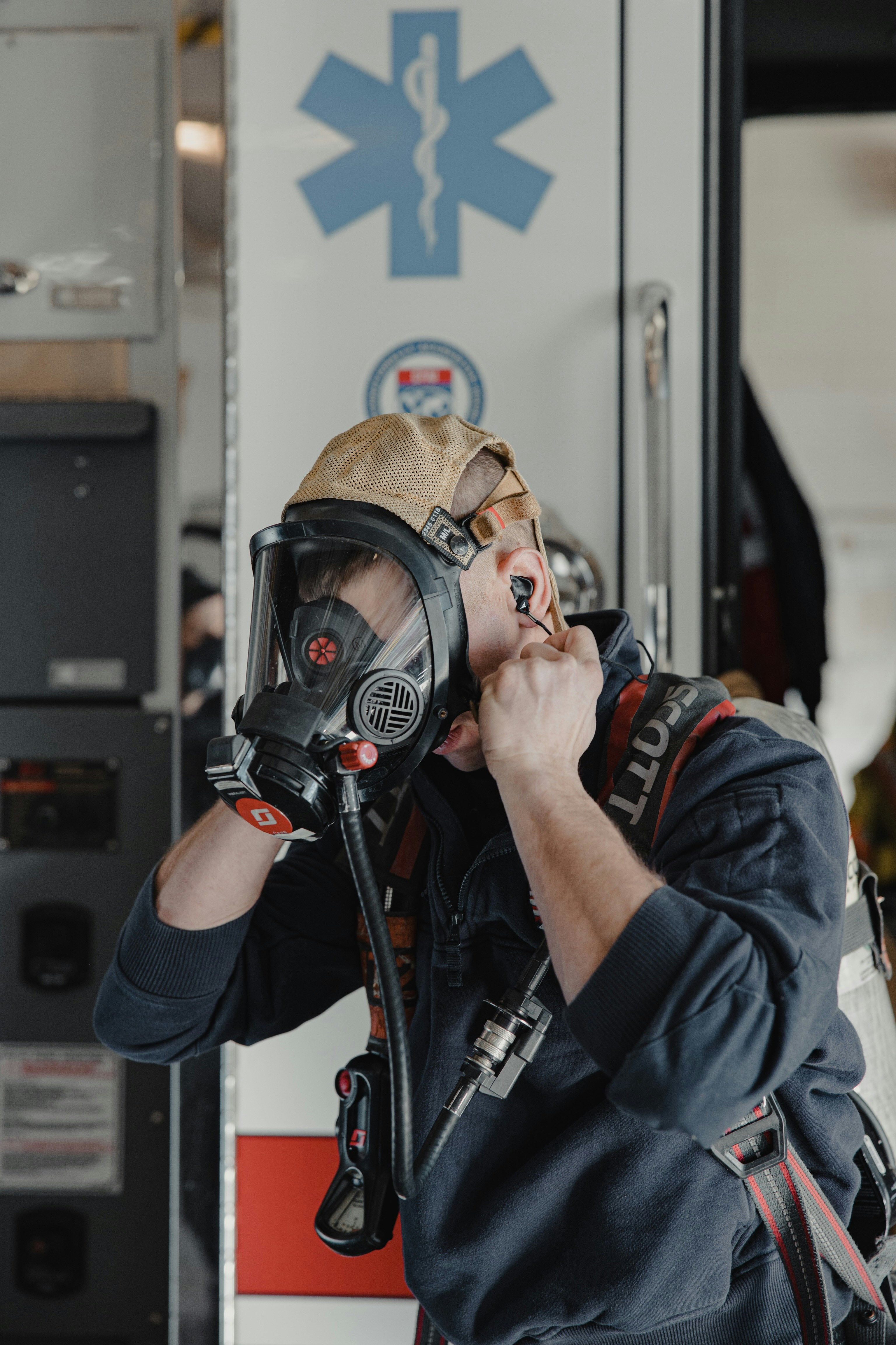 man in black and red jacket wearing black and gray gas mask